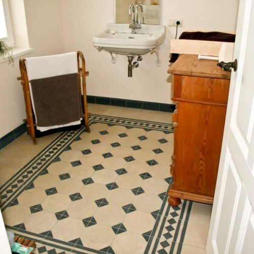 Zementfliesen im Gäste WC verlegt in einem Haus in Rhede | Muster 115, 405AB und Unifliesen in den Farben Elfenbein (M02) und Schwarzoliv (M53) | Referenznummer: 4396